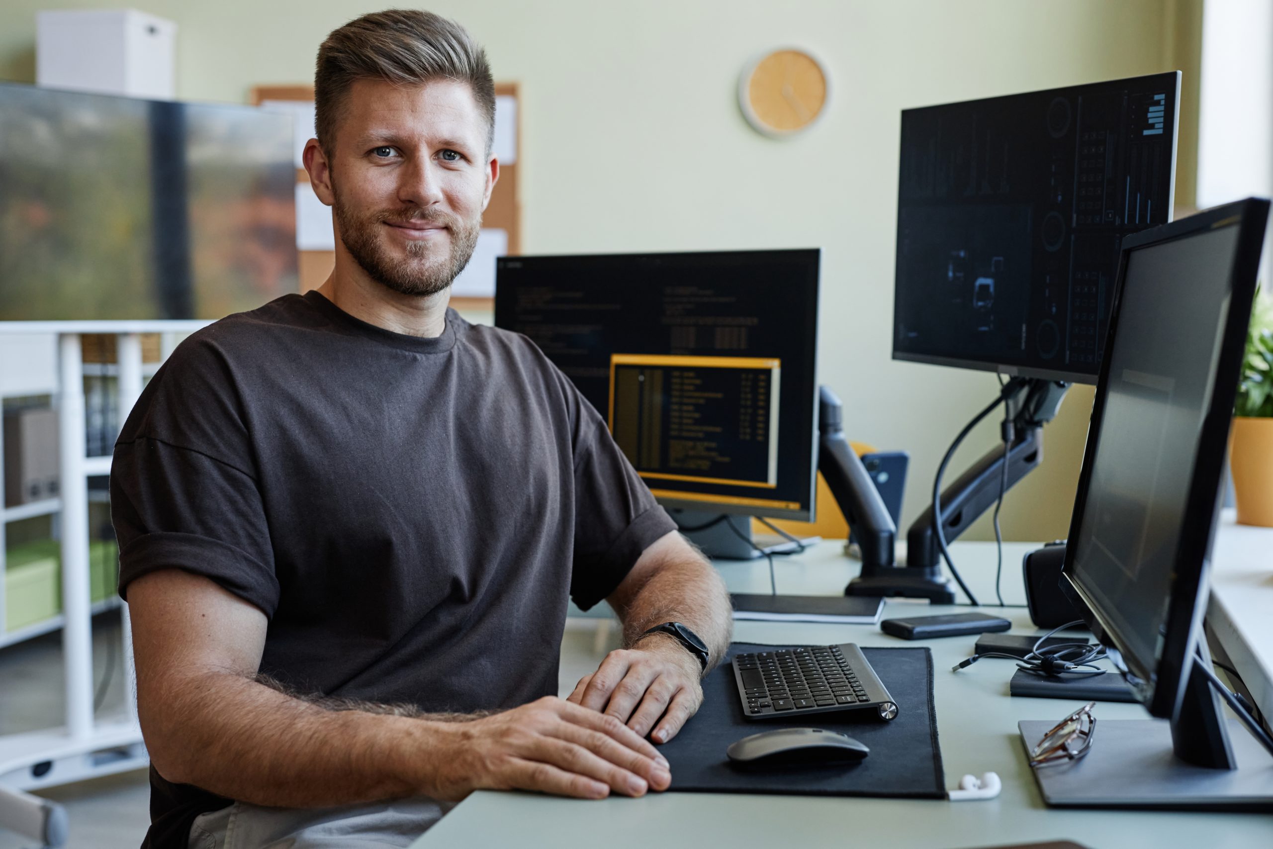 Portrait,Of,Smiling,Software,Developer,Looking,At,Camera,While,Sitting